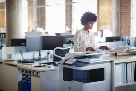 Woman-in-office-using-an-HP-PageWide-Managed-P77750z-2