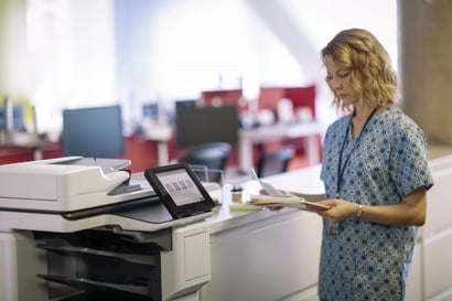 nurse standing by an hp mfp in an optimized healthcare print environment