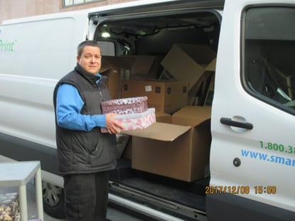 smartprint employee loading shoeboxes into van for the shoebox project