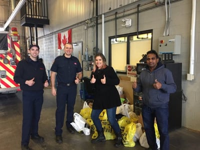 smartprint team members at the firehall with grocery bags for the winter food drive